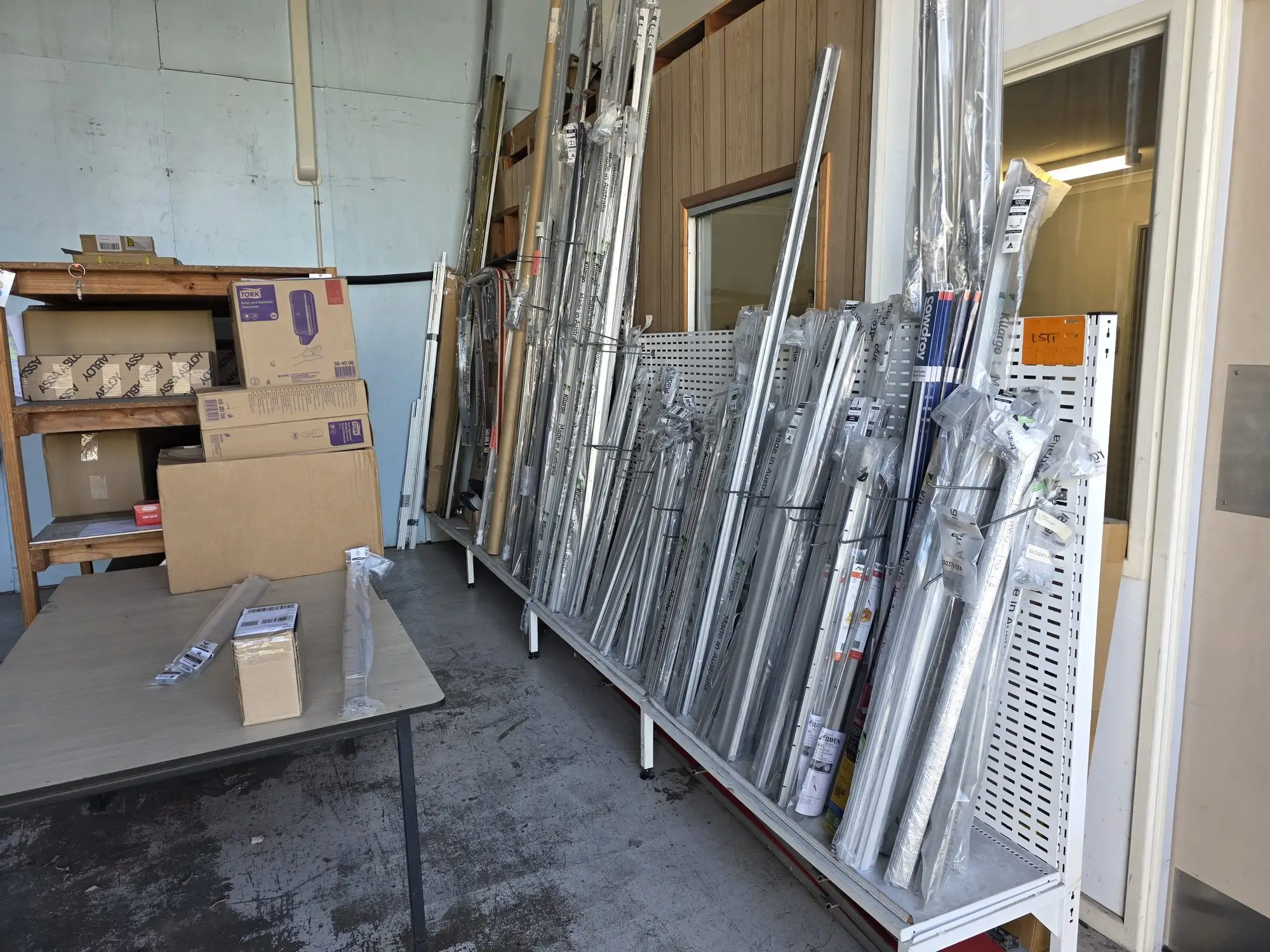 Door seals in their packs, standing on a rack in the warehouse.