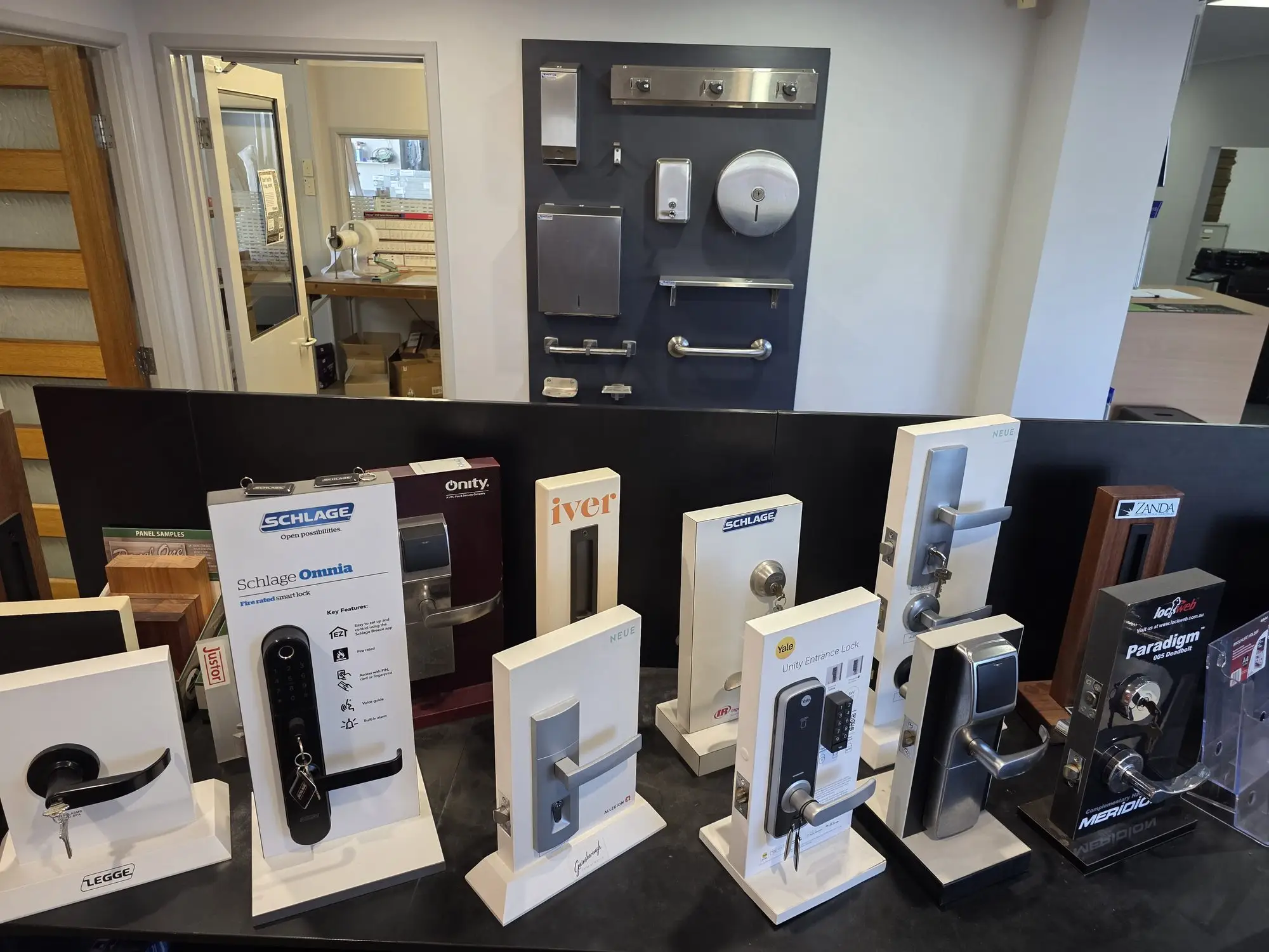 Smart locks, entrance locks and lever sets on the showroom display bench.