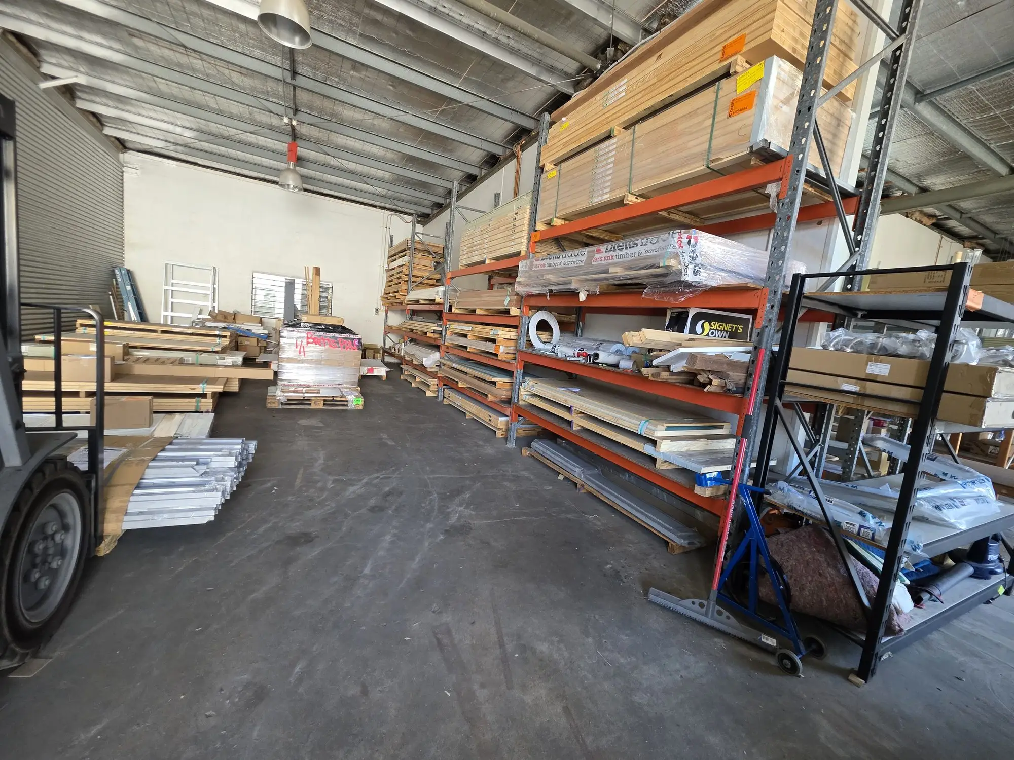 Pallet racking stacked with doors and door frames in the Buchan St warehouse.